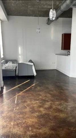 a living room with couches and a flat screen tv