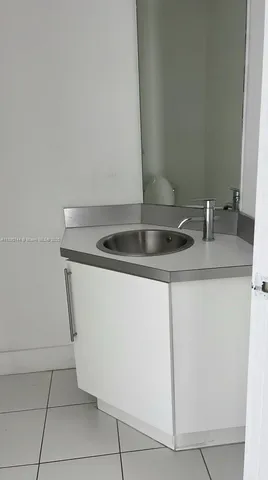 a bathroom with a white toilet and shower