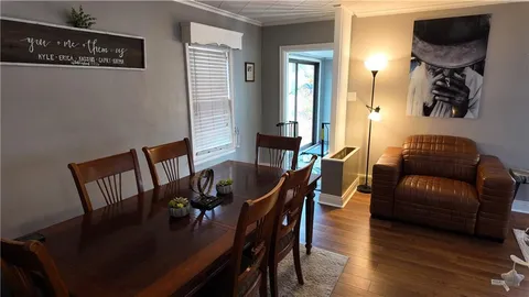 a view of a dining room with furniture and wooden floor