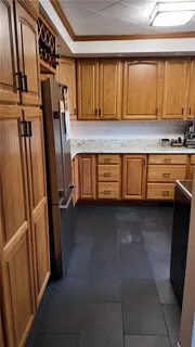 a kitchen with granite countertop a refrigerator and a stove