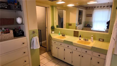 a bathroom with a double vanity sink and a mirror