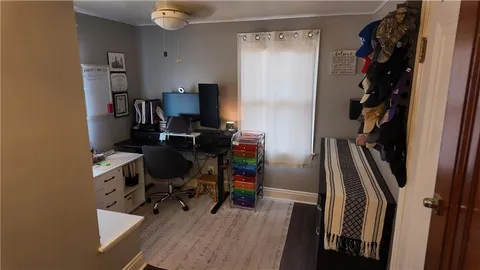 a view of a workspace with furniture and wooden floor