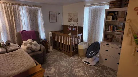 a bedroom with furniture and a book shelf