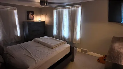 a bedroom with a bed and a mirror