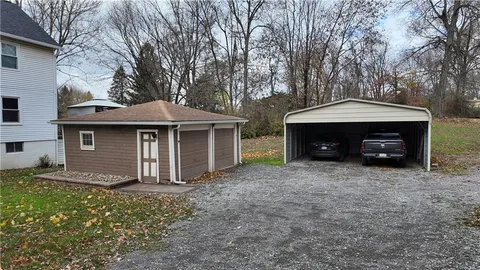 a front view of a house with a garden and yard