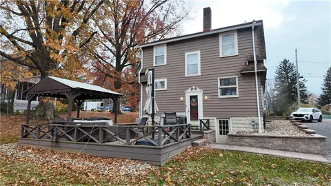 a view of a house with yard and sitting area