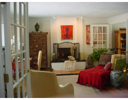 12 Uplands Road Littleton, MA 01460 - Photo 3 of 6 a living room with furniture a flat screen tv and a fireplace