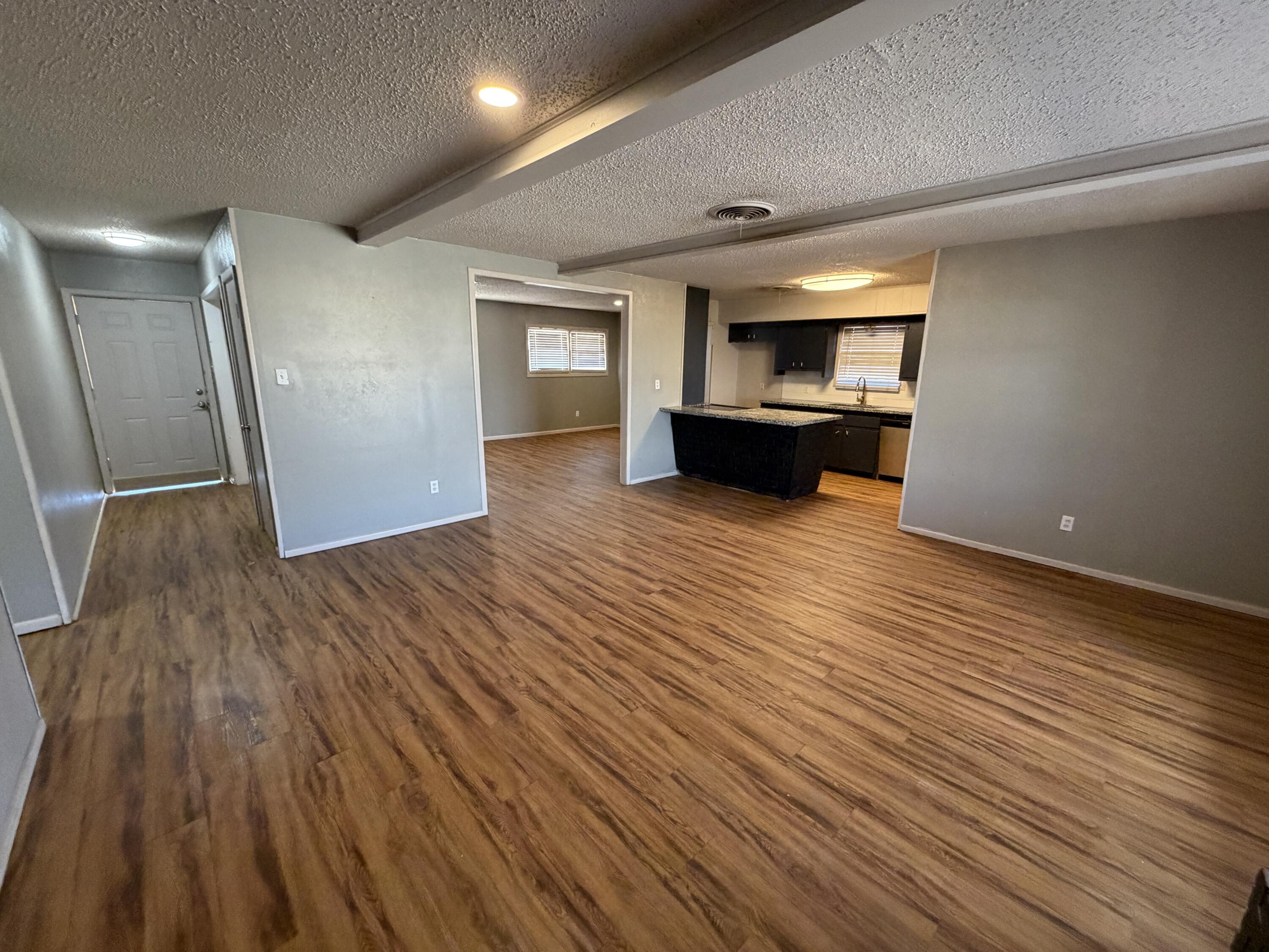2010 52nd Street Lubbock, TX 79412 - Photo 7 of 13 a view of an empty room with wooden floor fireplace and a window