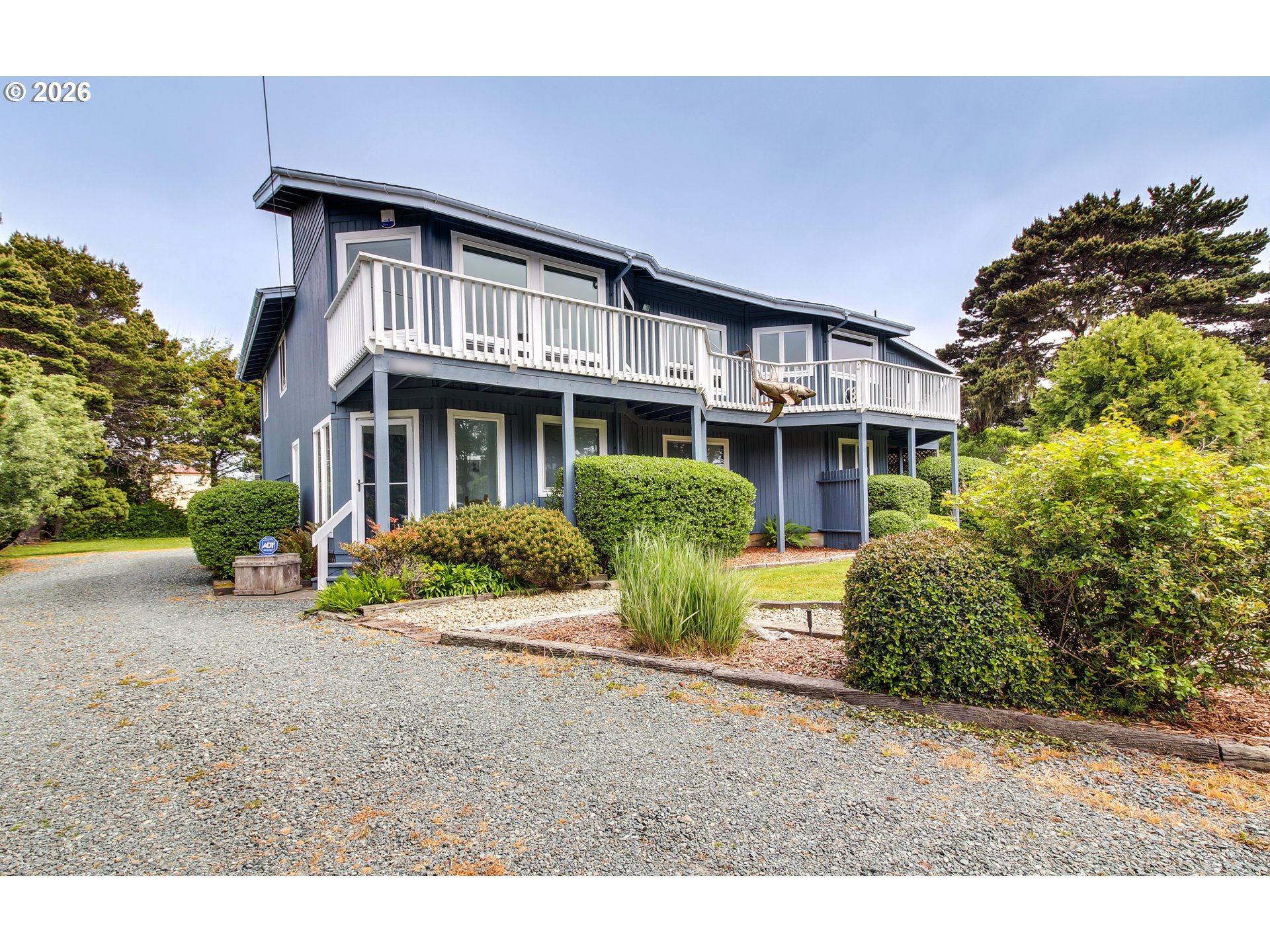 3085 Beach Loop Drive Southwest Bandon, OR 97411 - Photo 4 of 46 a front view of a house with a garden