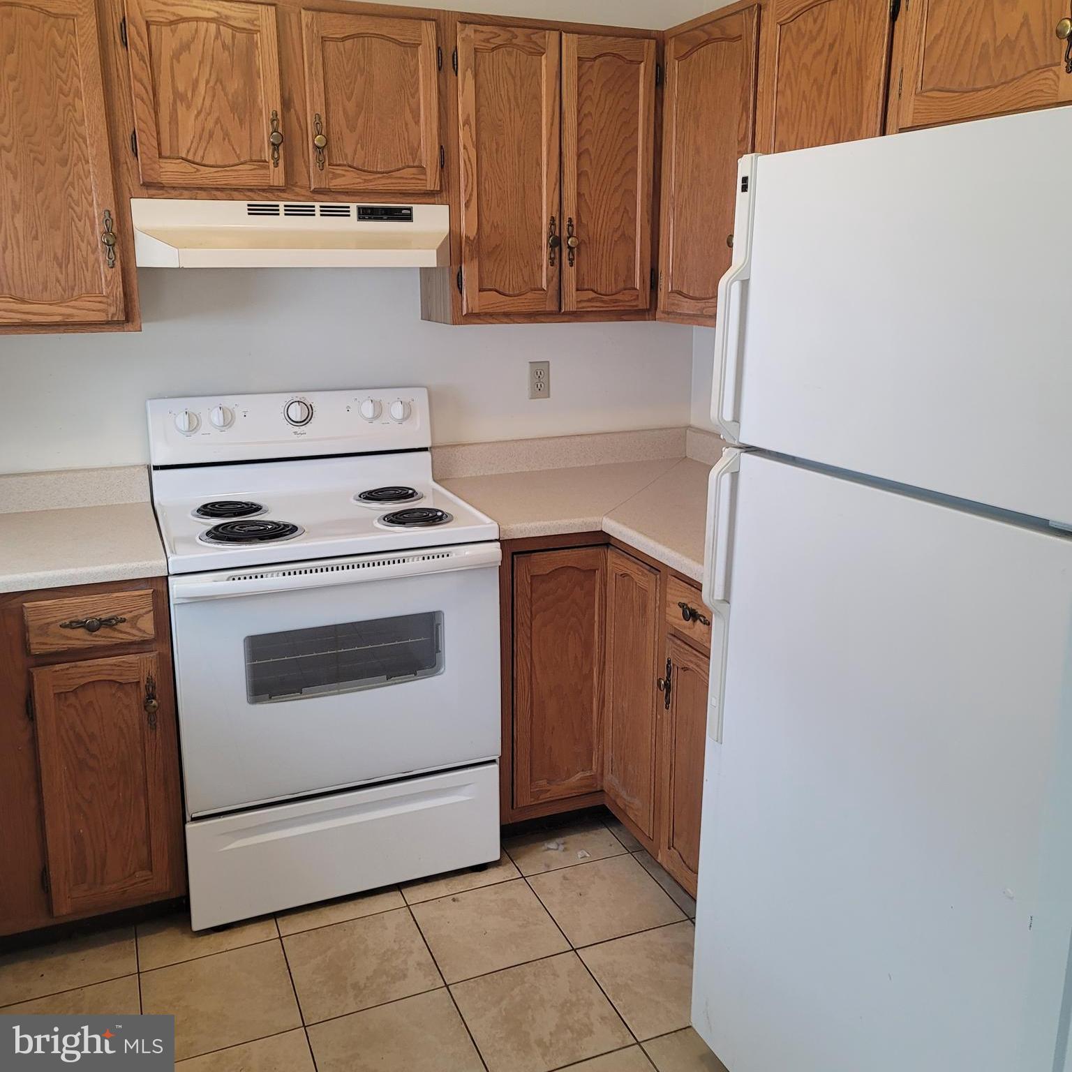 71 Leatherman Drive Falling Waters, WV 25419 - Photo 3 of 22 a white refrigerator freezer and a stove sitting inside of a kitchen with granite countertop white cabinets