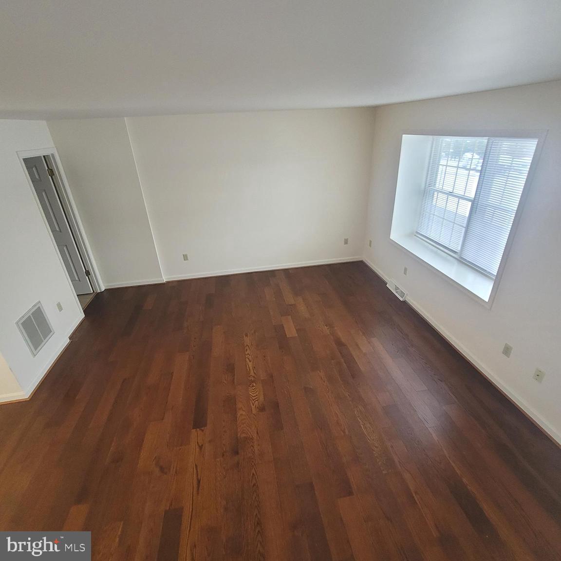 71 Leatherman Drive Falling Waters, WV 25419 - Photo 10 of 22 a view of an empty room with wooden floor and a window
