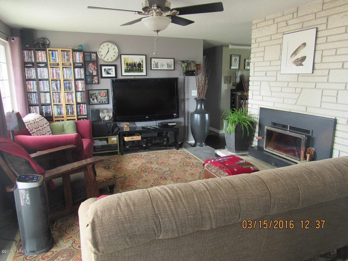 2841 McDonald Road Wapato, WA 98951 - Photo 6 of 11 a living room with furniture a flat screen tv and a fireplace