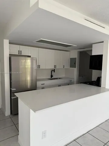a kitchen with stainless steel appliances a refrigerator and a microwave