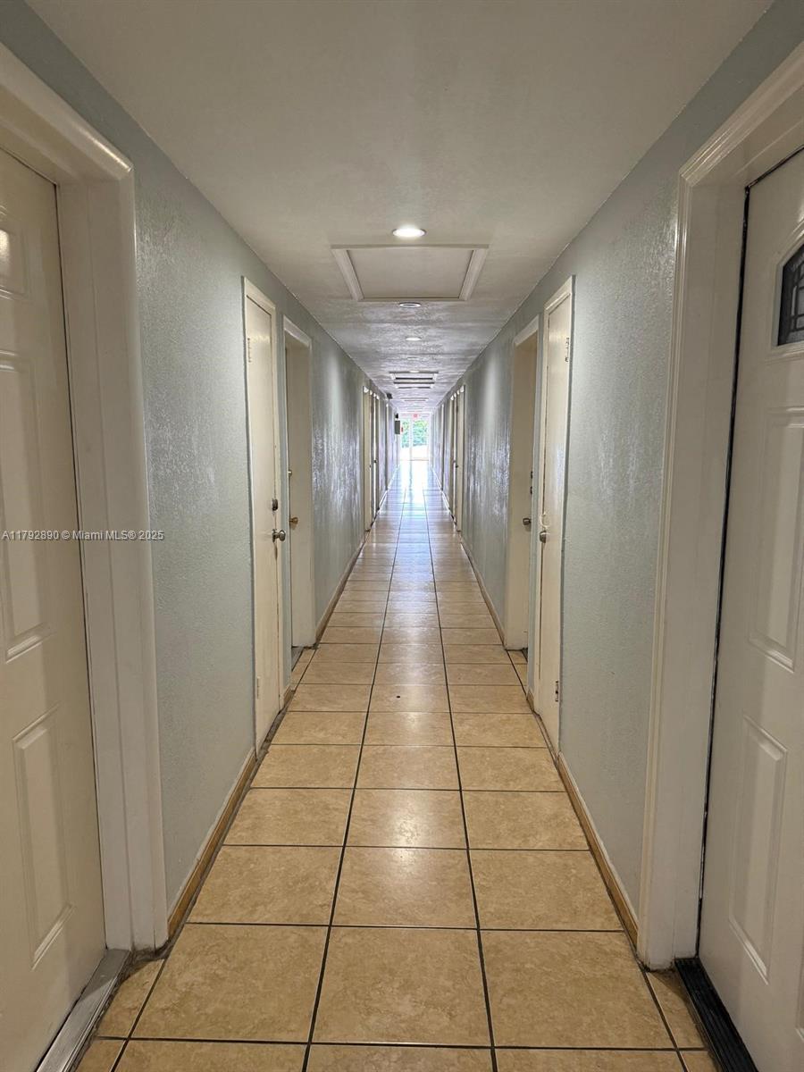 1350 West 53rd Street, Unit 33 Hialeah, FL 33012 - Photo 15 of 17 a hallway with view of a building