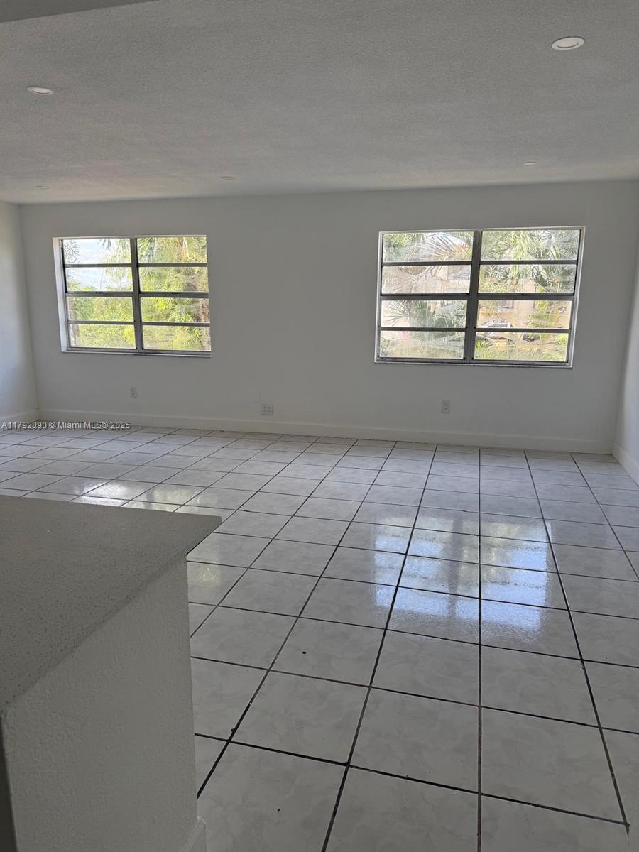 1350 West 53rd Street, Unit 33 Hialeah, FL 33012 - Photo 2 of 17 a view of an empty room with a window