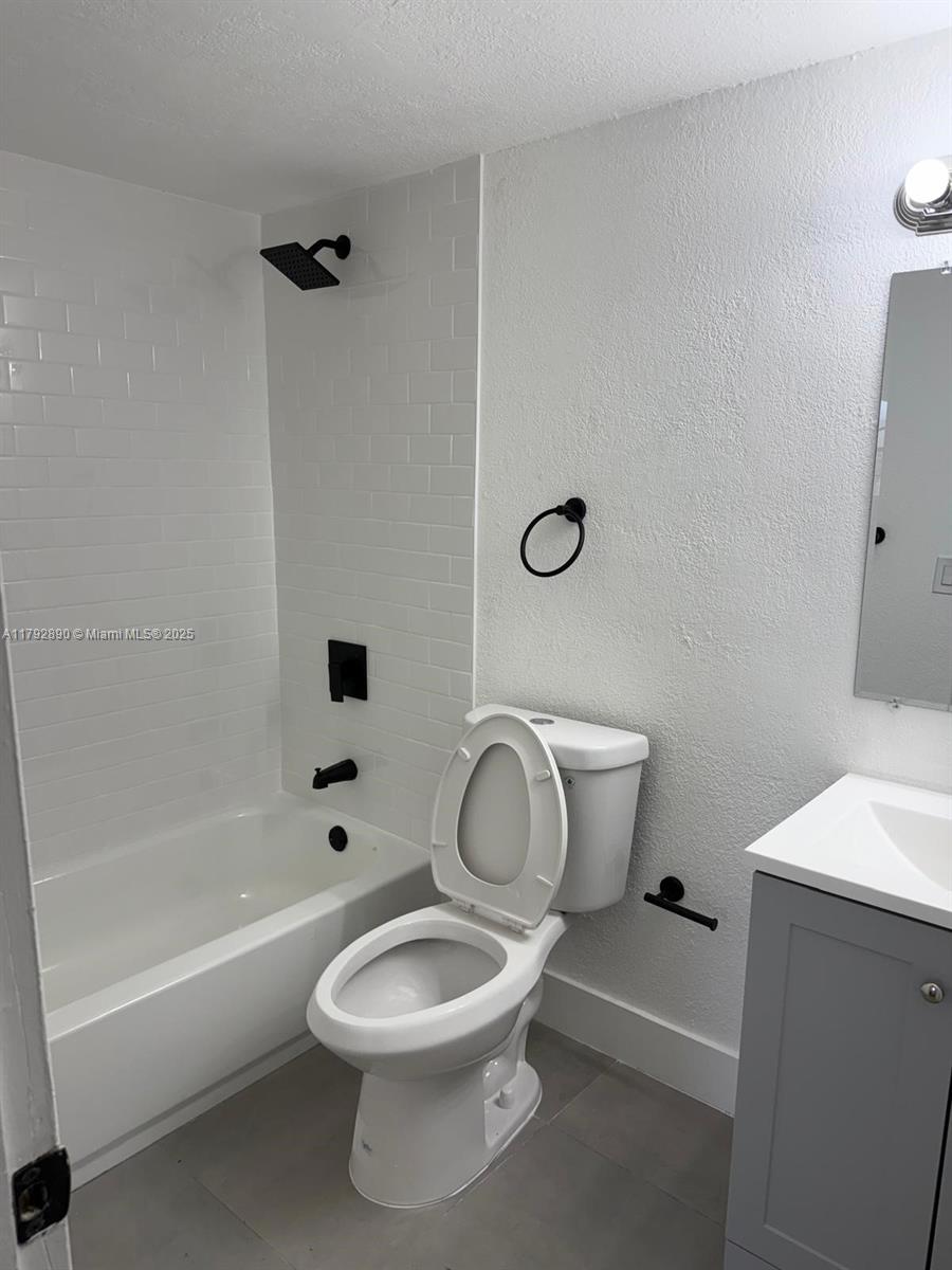 1350 West 53rd Street, Unit 33 Hialeah, FL 33012 - Photo 6 of 17 a white toilet sitting next to a bath tub