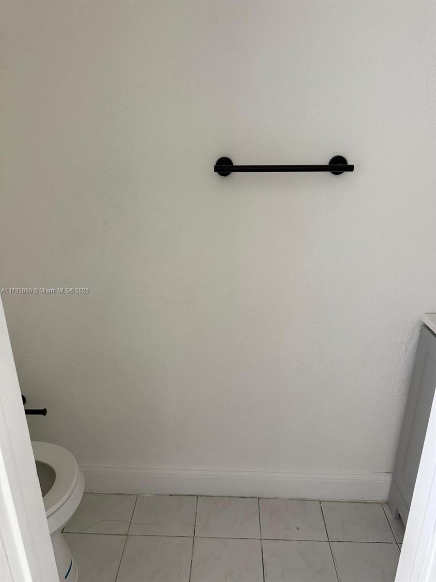 1350 West 53rd Street, Unit 33 Hialeah, FL 33012 - Photo 8 of 17 a bathroom with a toilet