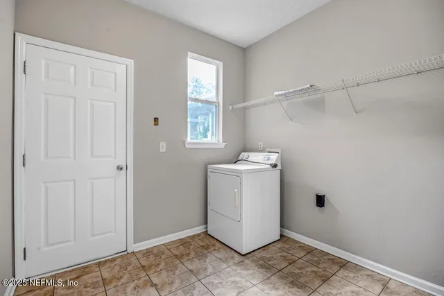 a utility room with a window dryer and washer