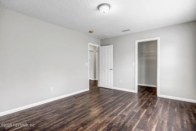 a view of a room with wooden floor