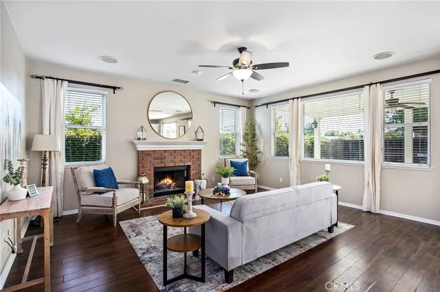 a living room with furniture a fireplace and a large window