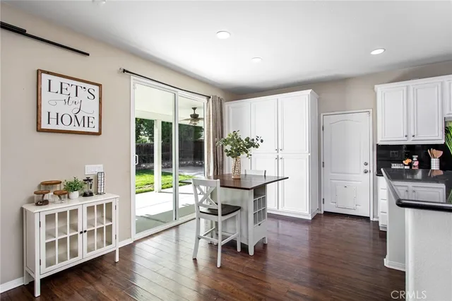 a kitchen with white cabinets and appliances