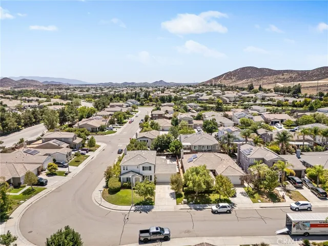 an aerial view of a house with a lake