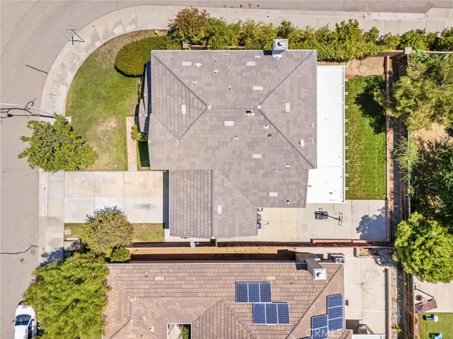 an aerial view of a house with a yard and garden