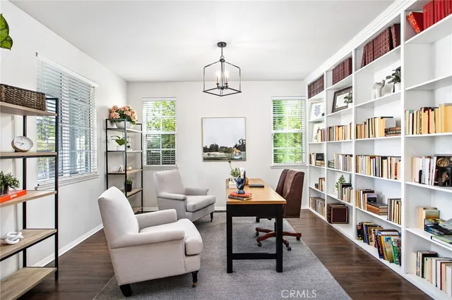 a reading room with furniture book shelf and wooden floor