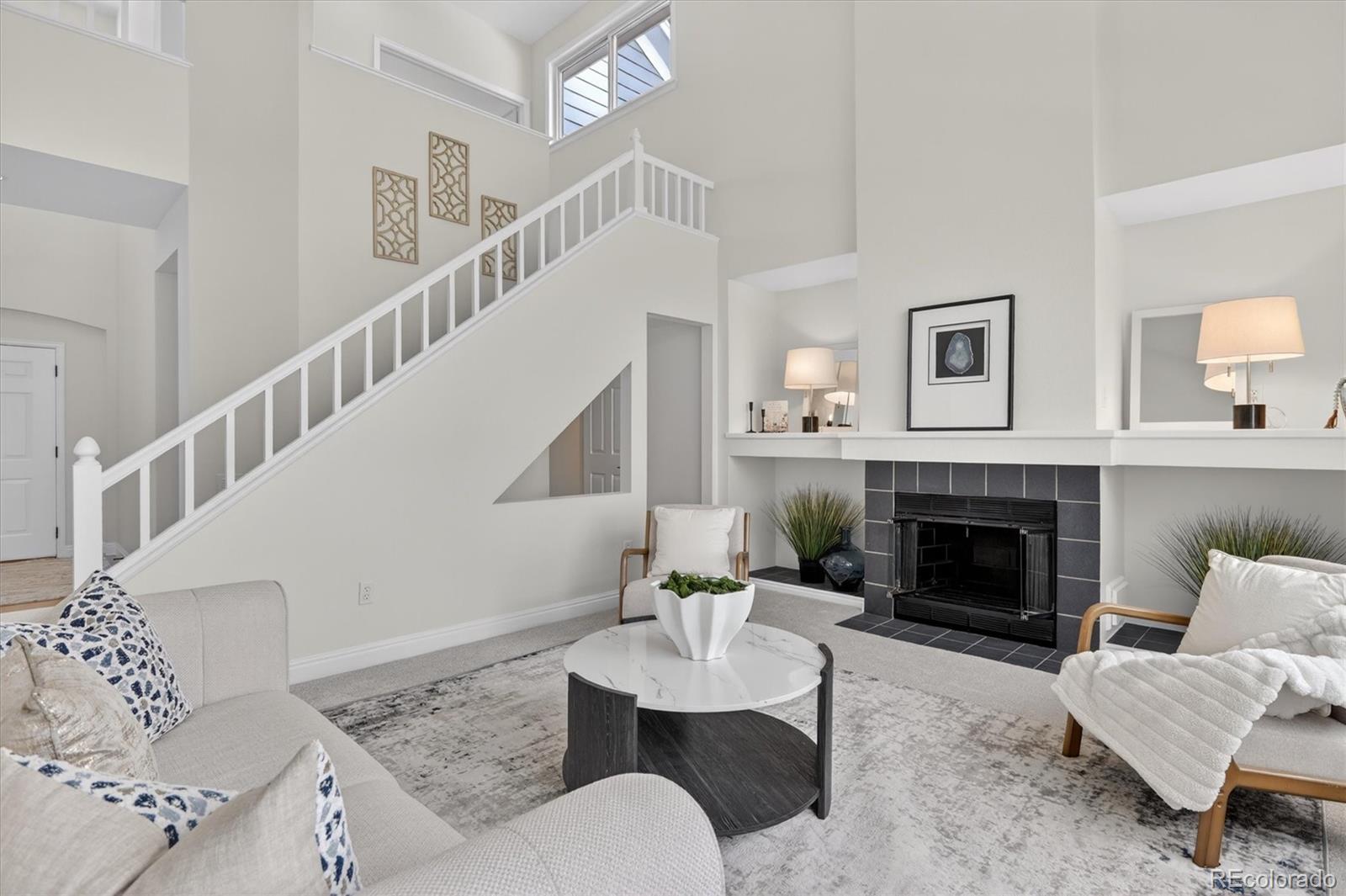 2445 East Lansdowne Court Highlands Ranch, CO 80126 - Photo 11 of 49 a living room with furniture and a fireplace
