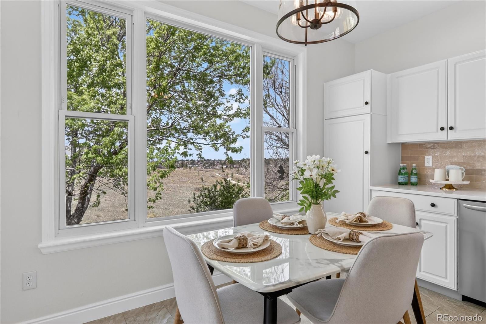 2445 East Lansdowne Court Highlands Ranch, CO 80126 - Photo 15 of 49 a view of a dining room with furniture window and outside view