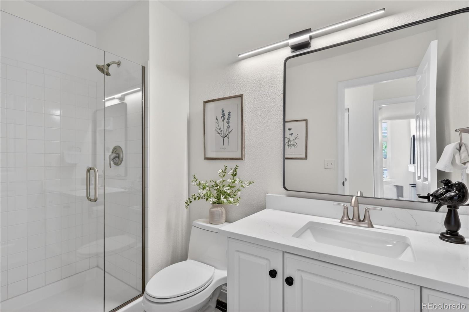 2445 East Lansdowne Court Highlands Ranch, CO 80126 - Photo 23 of 49 a bathroom with a sink toilet and shower