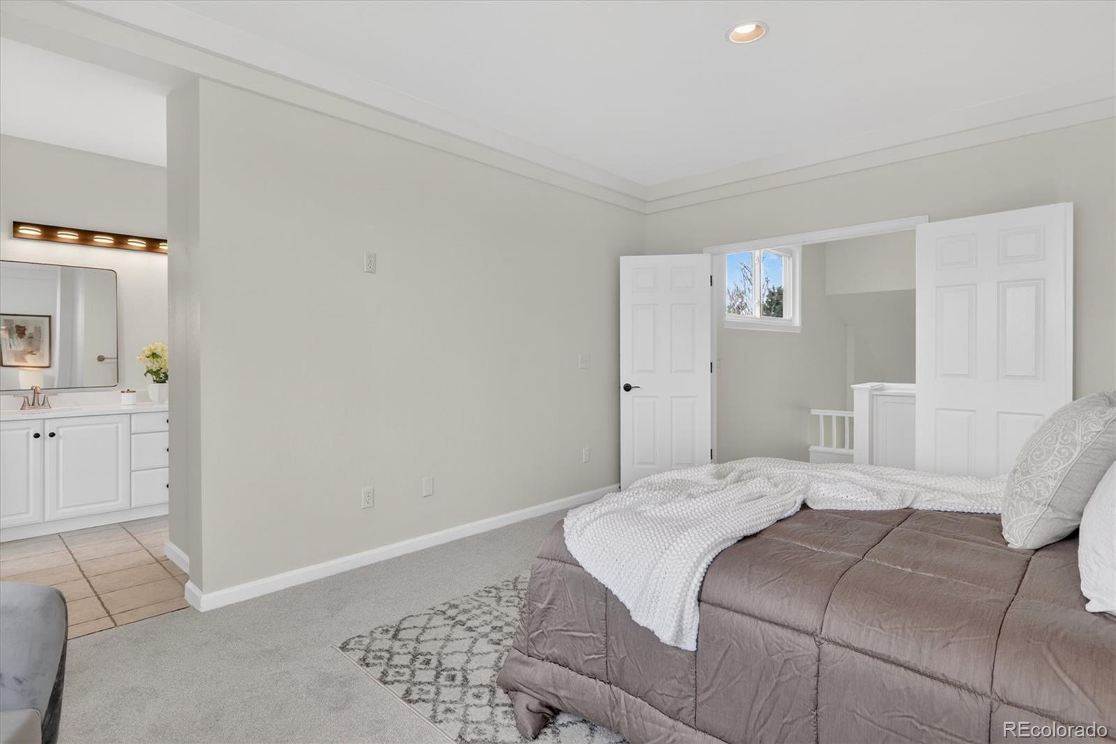 2445 East Lansdowne Court Highlands Ranch, CO 80126 - Photo 26 of 49 a bedroom with a bed and a cabinets
