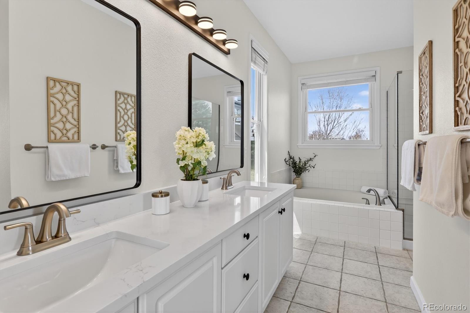 2445 East Lansdowne Court Highlands Ranch, CO 80126 - Photo 27 of 49 a bathroom with a tub sink and mirror