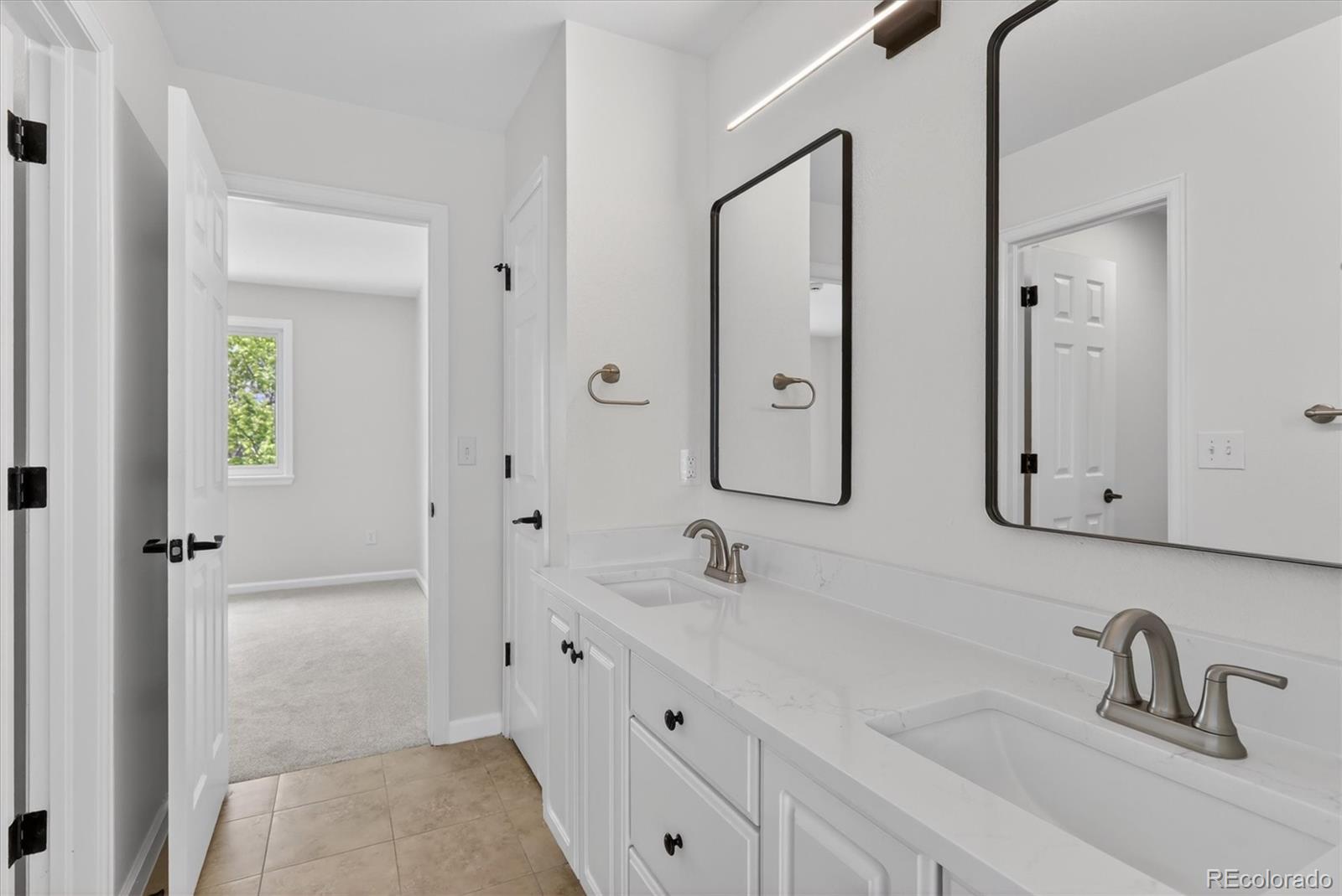 2445 East Lansdowne Court Highlands Ranch, CO 80126 - Photo 31 of 49 a bathroom with double vanity sink and a mirror