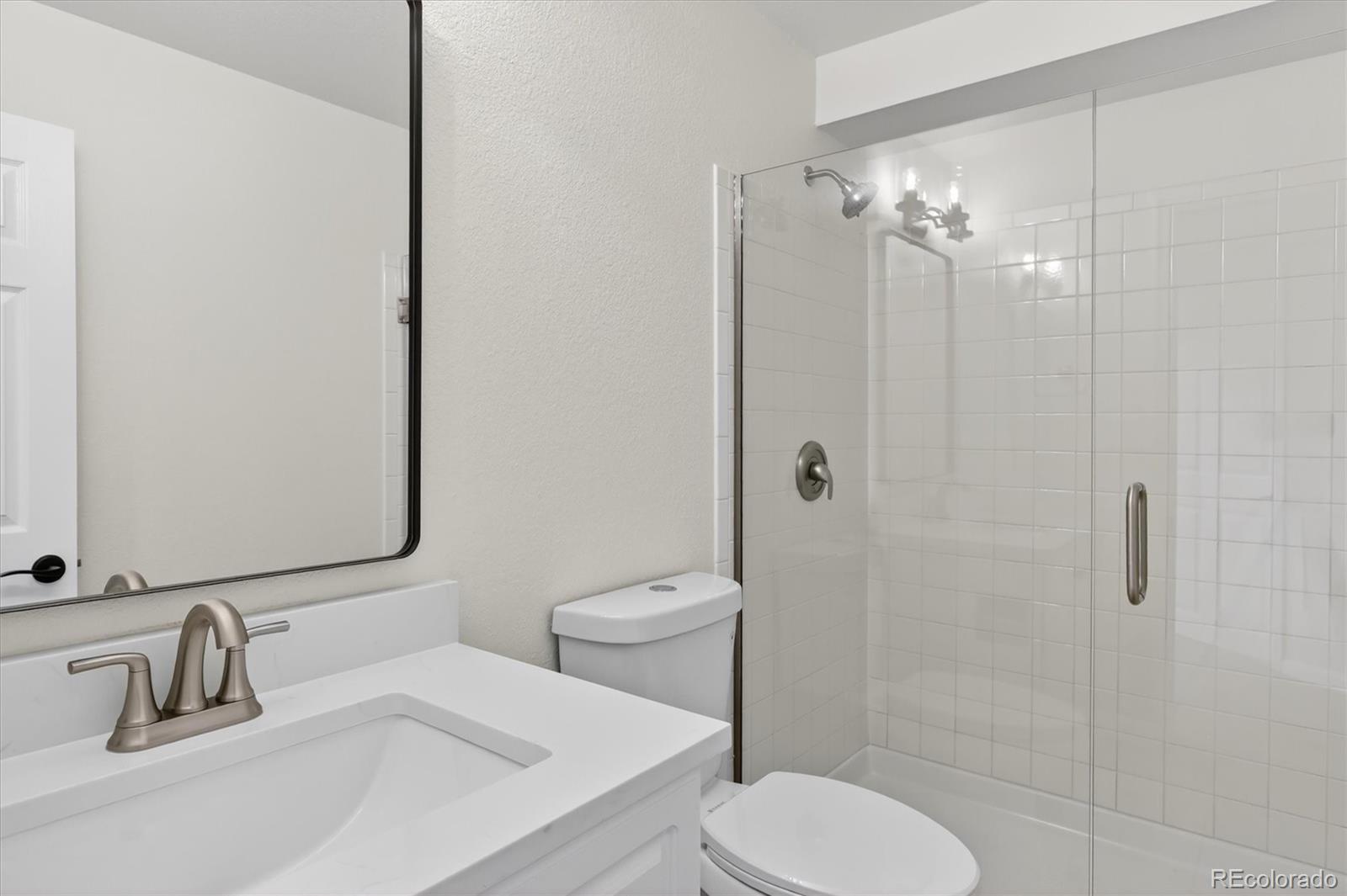2445 East Lansdowne Court Highlands Ranch, CO 80126 - Photo 37 of 49 a bathroom with a toilet a sink and shower