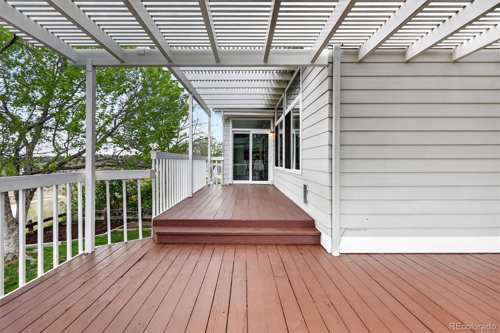 2445 East Lansdowne Court Highlands Ranch, CO 80126 - Photo 40 of 49 a view of backyard with a deck and wooden floor