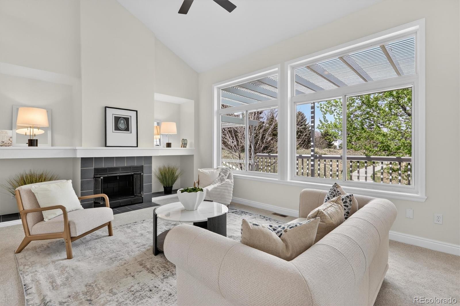 2445 East Lansdowne Court Highlands Ranch, CO 80126 - Photo 9 of 49 a living room with furniture a fireplace and a large window
