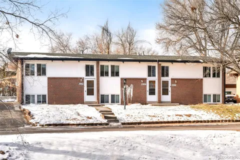 a house that has a tree in front of it