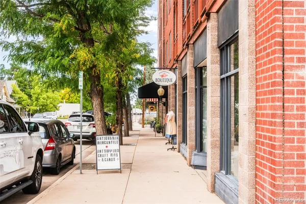 a view of a street with stores