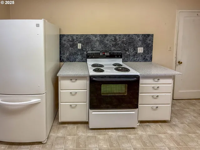 a stove top oven sitting inside of a kitchen