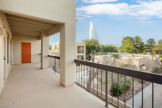 a view of a balcony with furniture and a potted plant