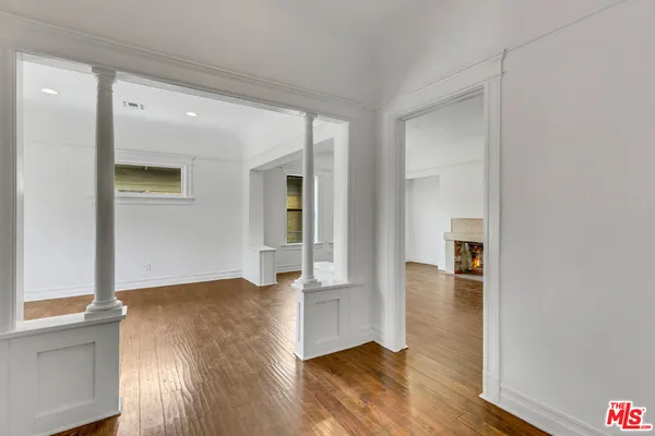 a view of room with window and wooden floor
