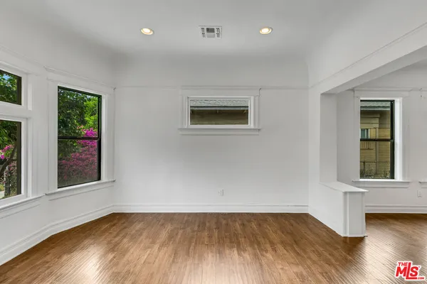 a view of wooden floor and windows in a room