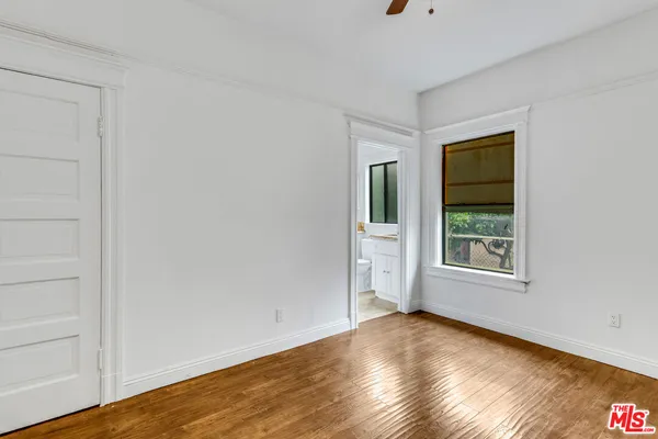 a view of a room with a window and wooden floor