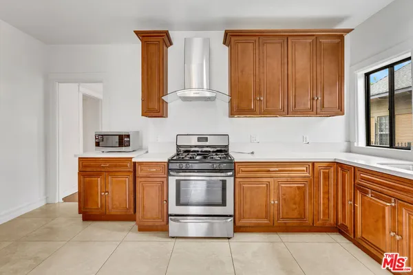 a kitchen with white cabinets and appliances