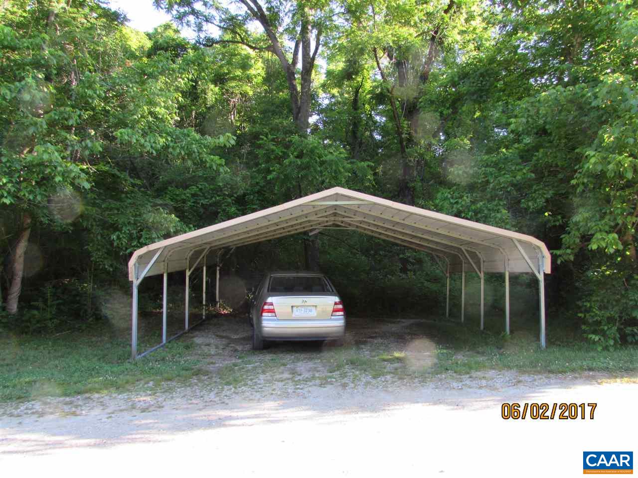 668 Peters Hollow Road Monroe, VA 24574 - Photo 22 of 50 a side view of a house with a garden and parking space