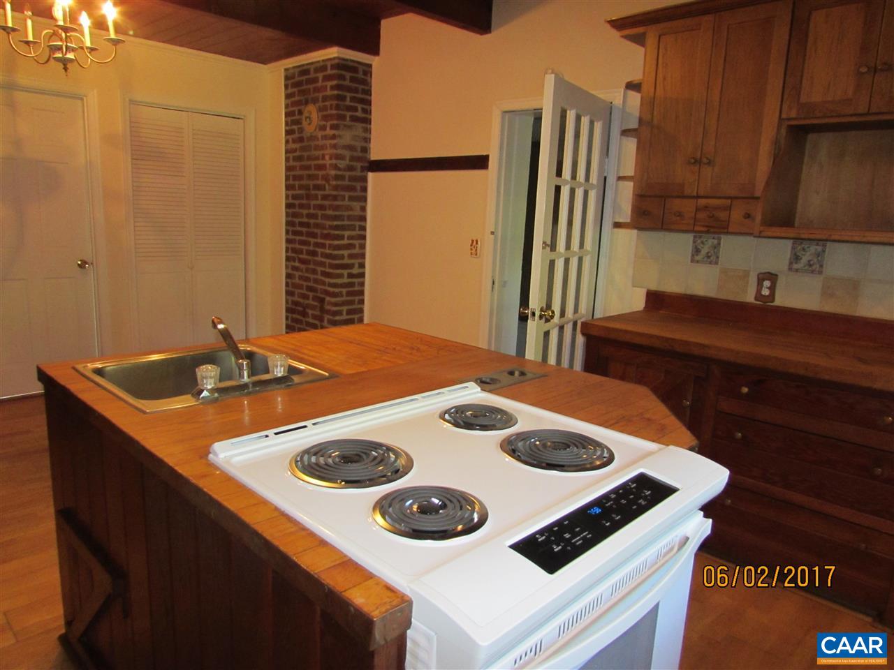 668 Peters Hollow Road Monroe, VA 24574 - Photo 34 of 50 a kitchen with a sink a stove and a refrigerator