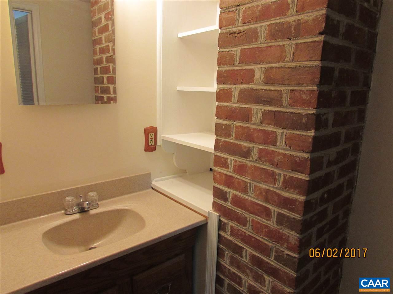 668 Peters Hollow Road Monroe, VA 24574 - Photo 46 of 50 a bathroom with a sink and a mirror