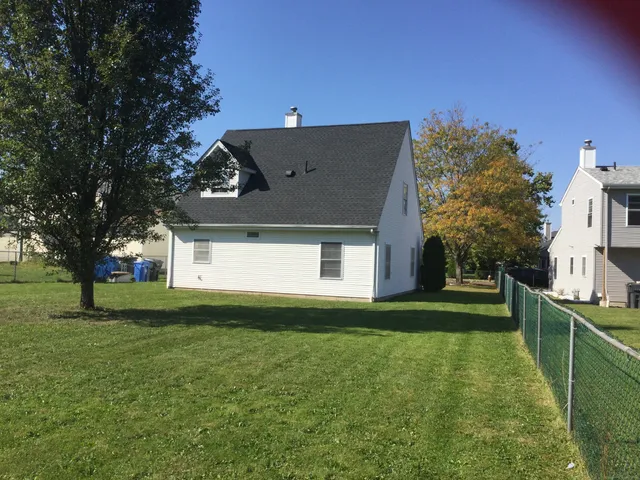 a front view of house with yard and trees
