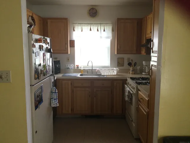 a kitchen with a sink stove and refrigerator